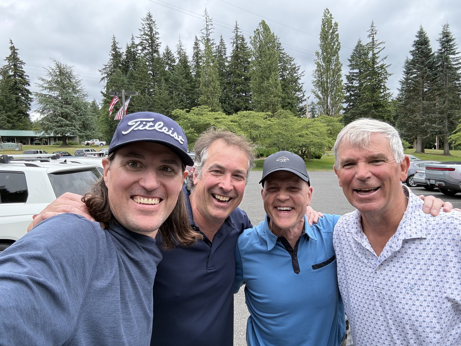 Trevor Johnson, Chris Clogston and the Uhlar brothers posing in the clubhouse parking lot at Bellingham, 2026
